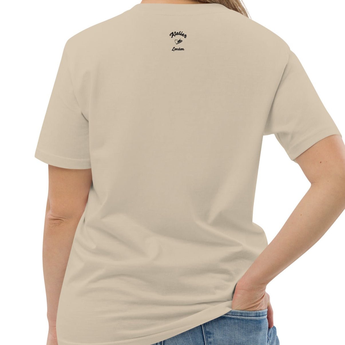 A dusty beige organic t-shirt featuring a symmetrical graphic of two colorful seahorses with bunny ears and floral details.