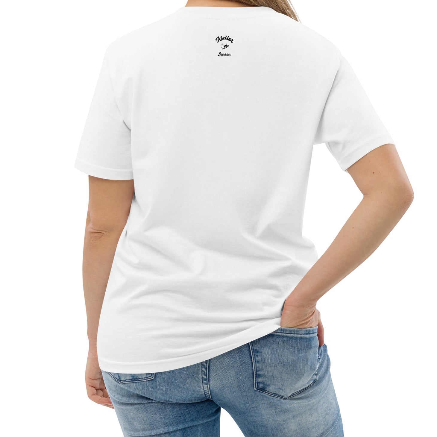 A model wearing the white  organic t-shirt featuring a symmetrical graphic of two colorful seahorses with bunny ears and floral details.