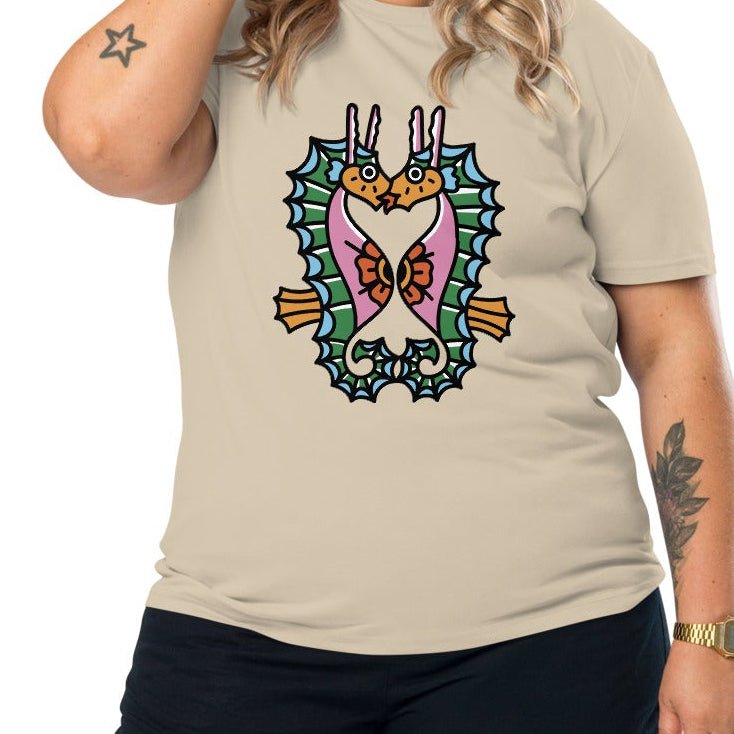 A dusty beige organic t-shirt featuring a symmetrical graphic of two colorful seahorses with bunny ears and floral details.