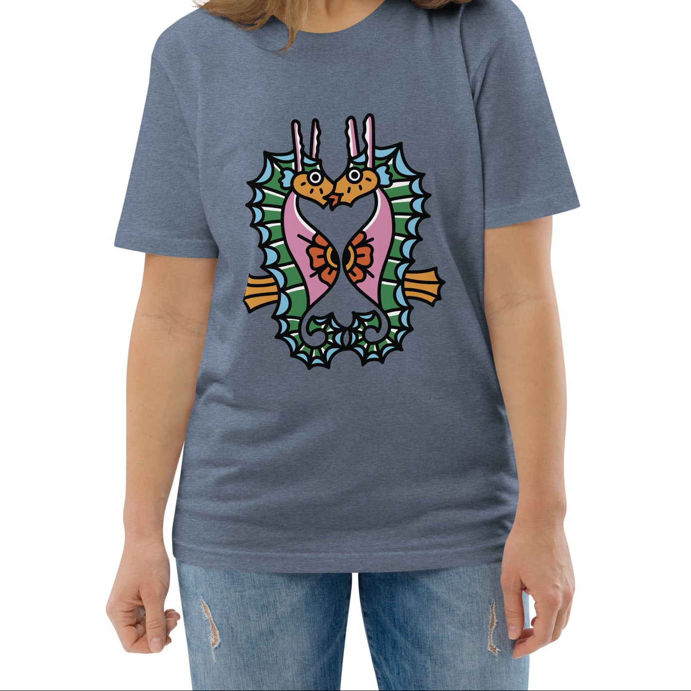 A denim blue organic t-shirt featuring a symmetrical graphic of two colorful seahorses with bunny ears and floral details.