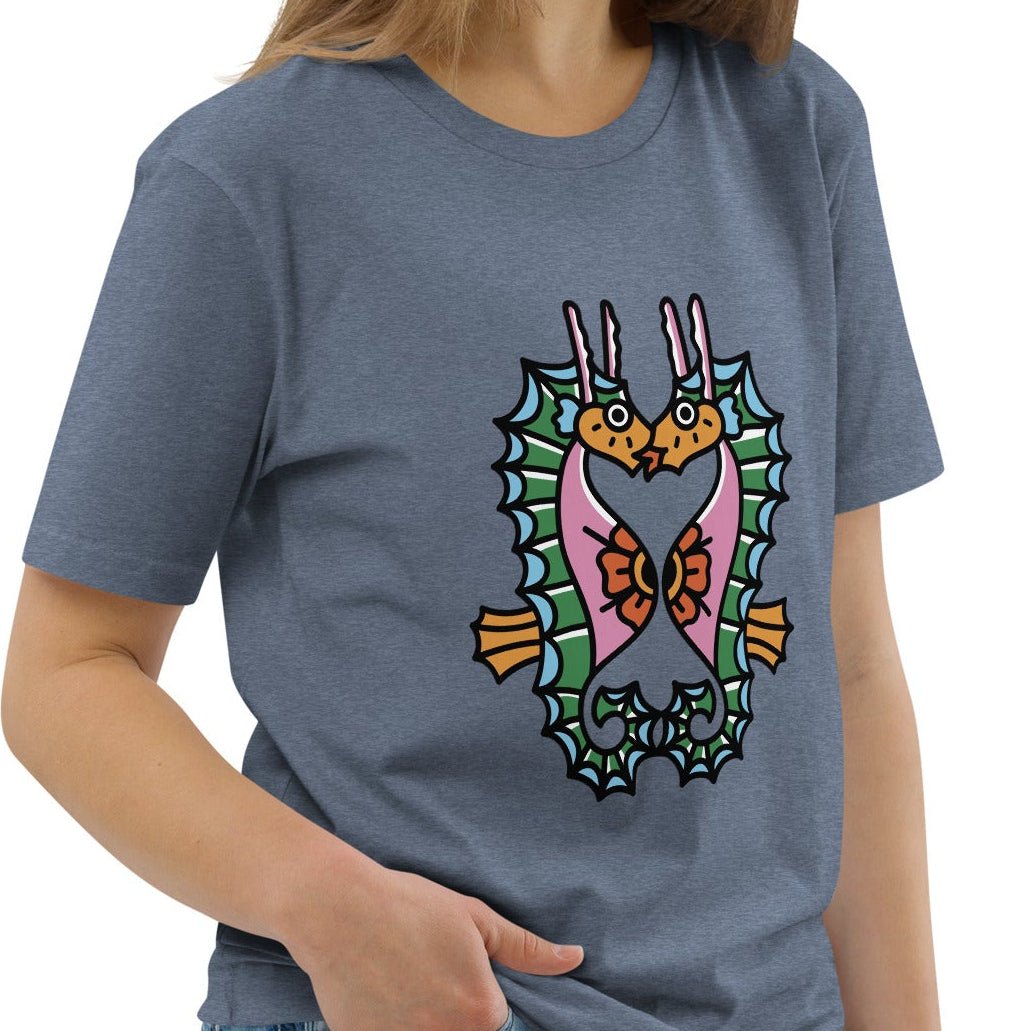 A denim blue organic t-shirt featuring a symmetrical graphic of two colorful seahorses with bunny ears and floral details.
