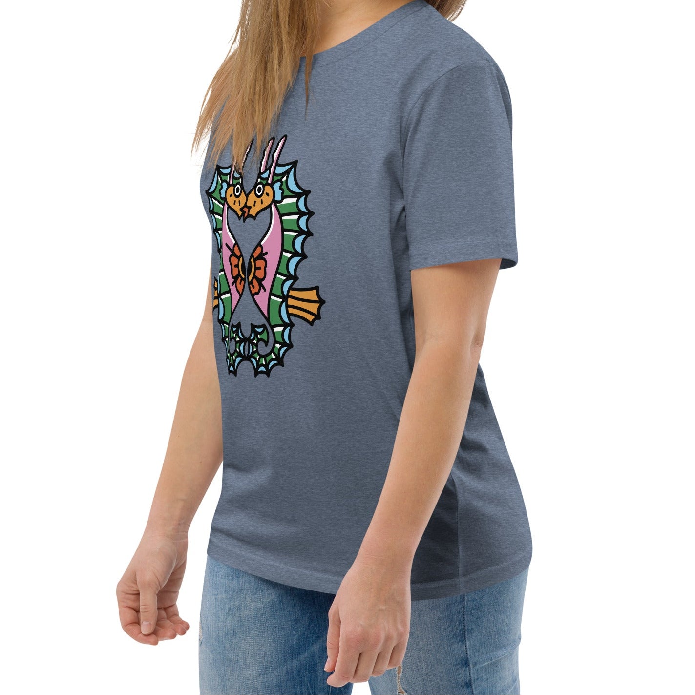 A denim blue organic t-shirt featuring a symmetrical graphic of two colorful seahorses with bunny ears and floral details.