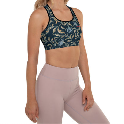 a model wearing the venice performance bra featuring a parsley and floral pattern in dark blue with beige and light blue details, and the text City Babe printed at the top front left side.