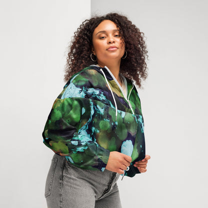 A model wearing The Abstract Crop Shell, showing the high-fashion, cropped silhouette and the abstract expressionism print in green and blue hues.