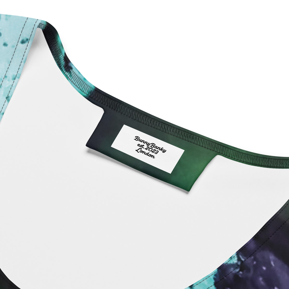 the abstract flow performance tank, a a sleeveless athletic tank top with a green, teal, and black abstract watercolor pattern
