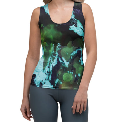A woman modeling  the abstract flow performance tank, a a sleeveless athletic tank top with a green, teal, and black abstract watercolor pattern, paired with gray leggings, against a plain white background.