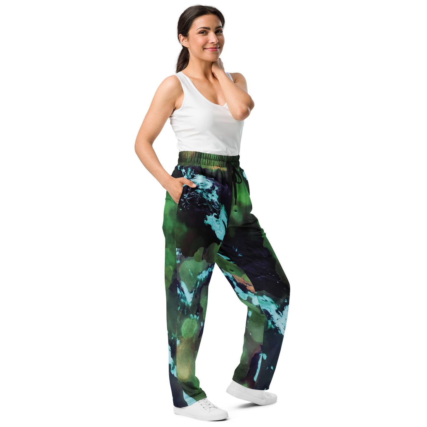A model wearing The Abstract Flow Joggers, showing the wide-leg cut and the abstract expressionism-inspired print in green and blue hues.