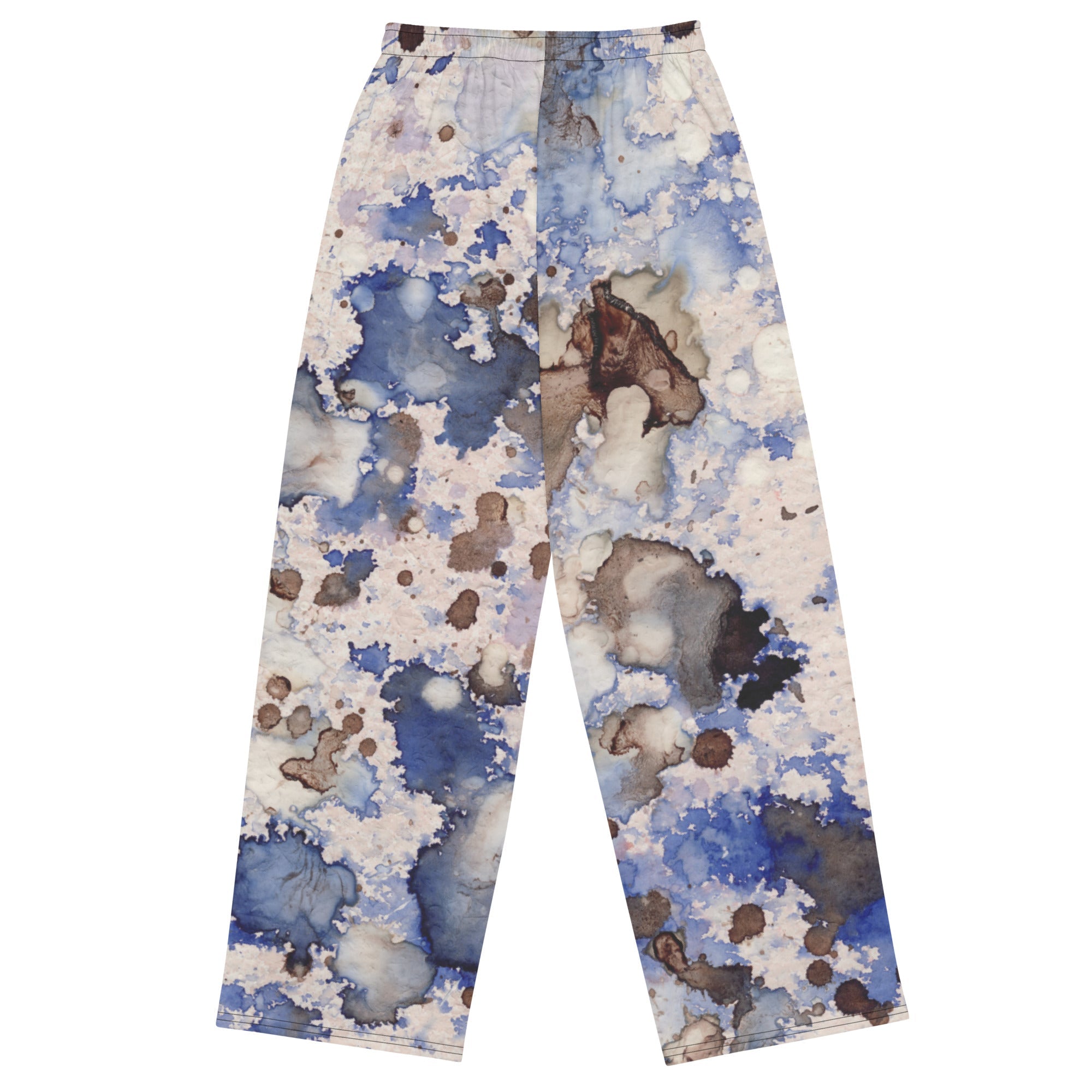 A model wearing the Amalfi Resort flow joggers in a blue and white abstract print  posing against a solid white background.