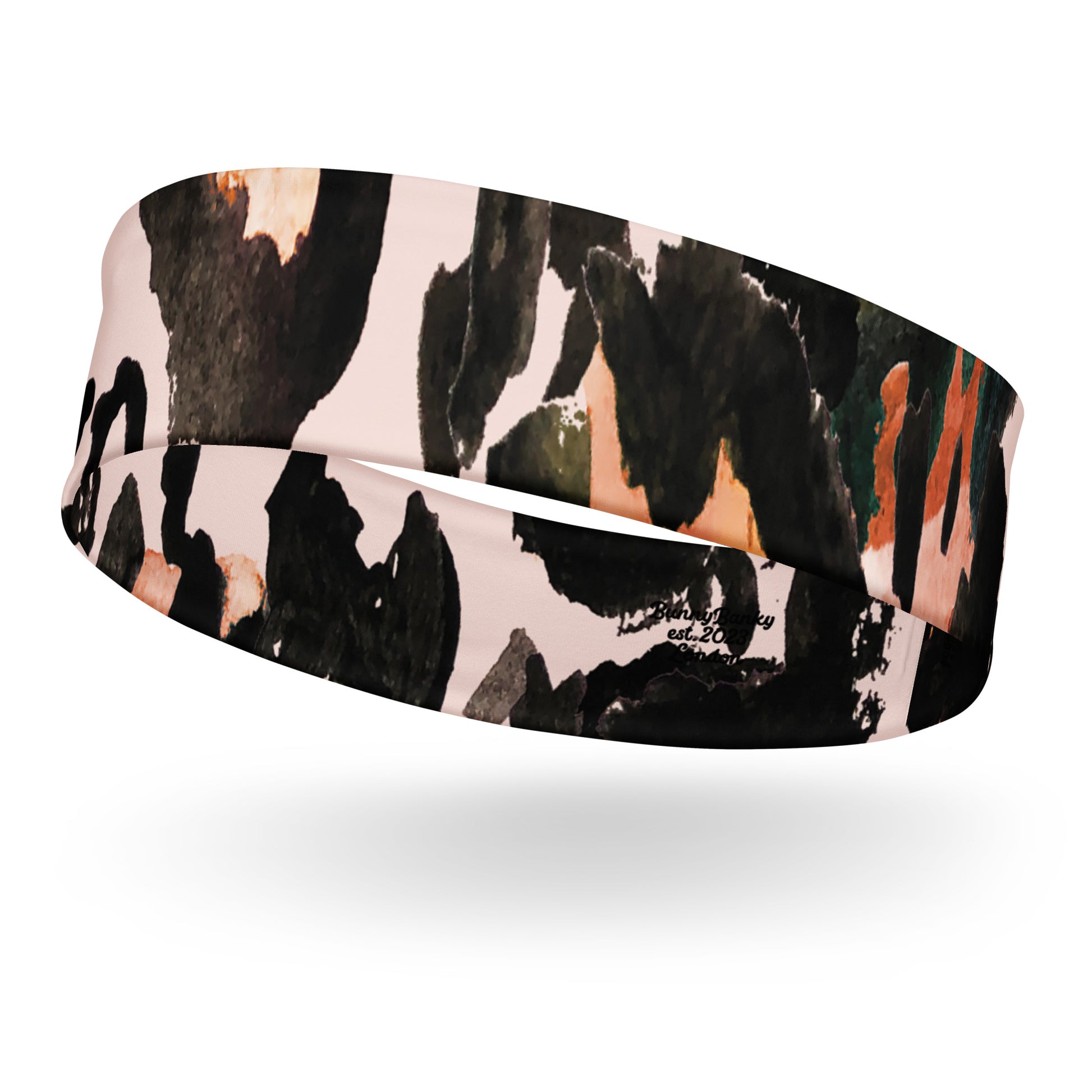 Close-up of the Amazonia headband showing the moisture-wicking fabric and vibrant animal print pattern
