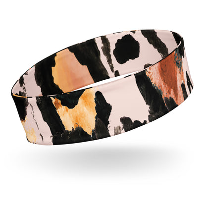 Close-up of the Amazonia headband showing the moisture-wicking fabric and vibrant animal print pattern