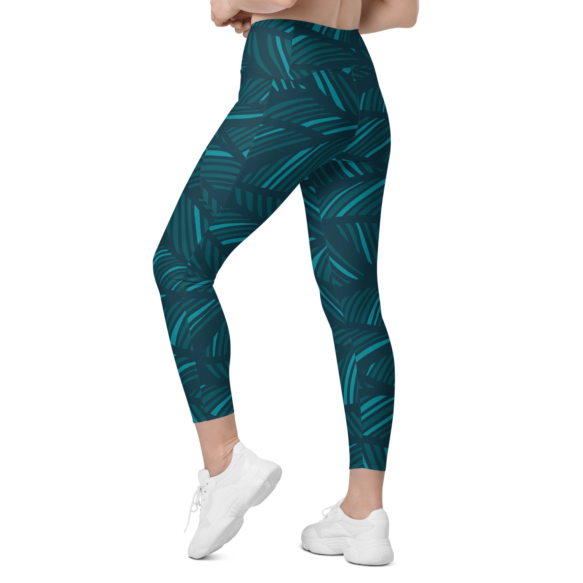 A model wearing The Amazonia Sculpt Leggings, showing the sculpting fit and the smooth dark green curved line print.