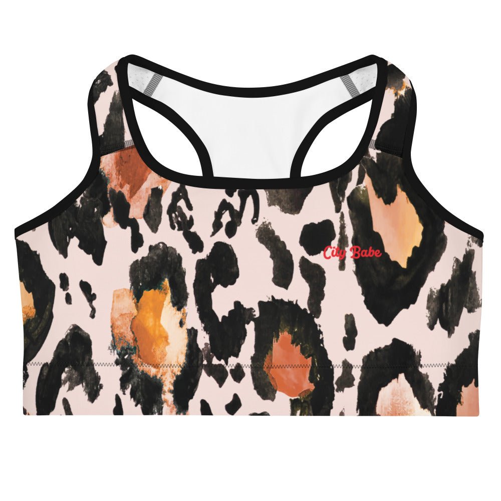 A close up of The Amazonia Performance Bra, showing the supportive fit, the fierce animal print, and the "City Babe" text printed in red on the front.