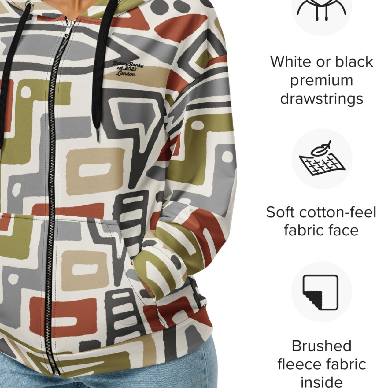 Close-up of The Amsterdam Zip Hoodie fabric, highlighting the textured, earthy tones of the geometric pattern and the soft feel of the 95% recycled polyester.