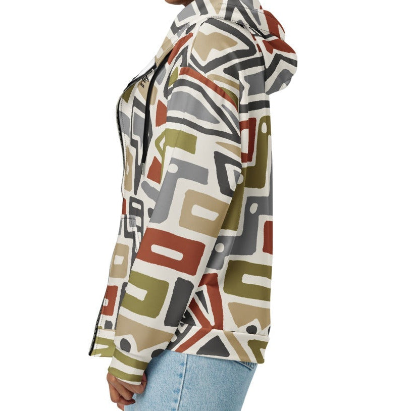 A model wearing The Amsterdam Zip Hoodie from BunnyBankY, showing the secure fit and the geometric futurism pattern in rich, earthy tones.