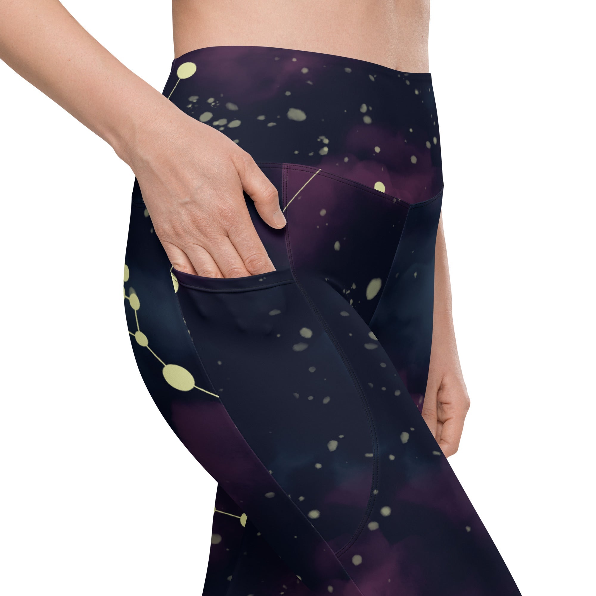 A model wearing The Andromeda Sculpt Leggings, showcasing the sculpting fit and the distinctive yellow star constellation print on the dark purple-to-black gradient fabric. The background features a subtle cosmic nebula.