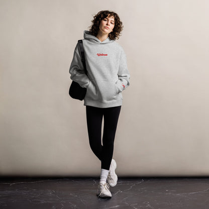 A model wearing The Angel Wellness Hoodie, showing the oversized fit and the embroidered "Wellness" text on the chest.