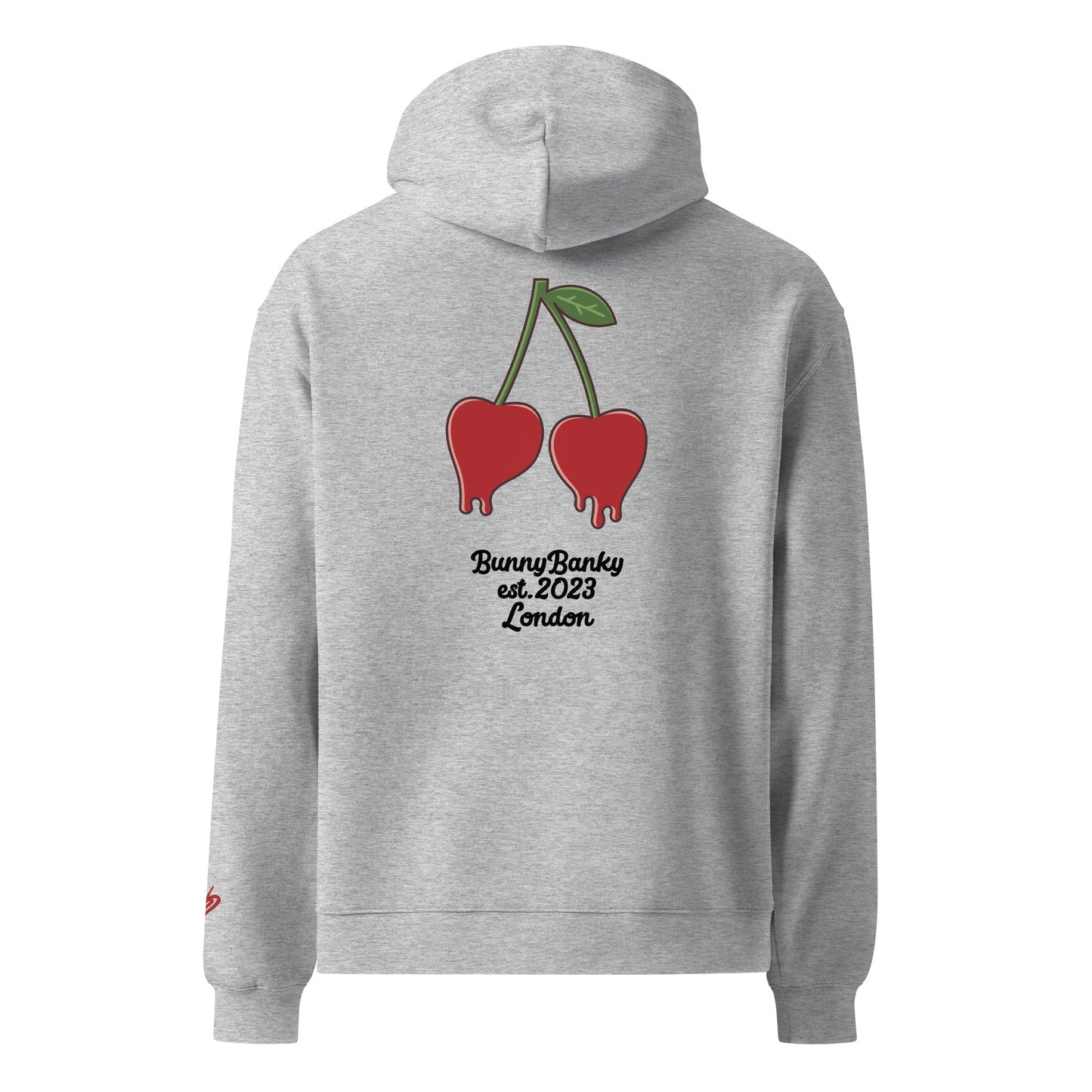 A close-up of the back of The Angel Wellness Hoodie, featuring the playful, pop-art cherry print and the heritage signature on the sleeve.