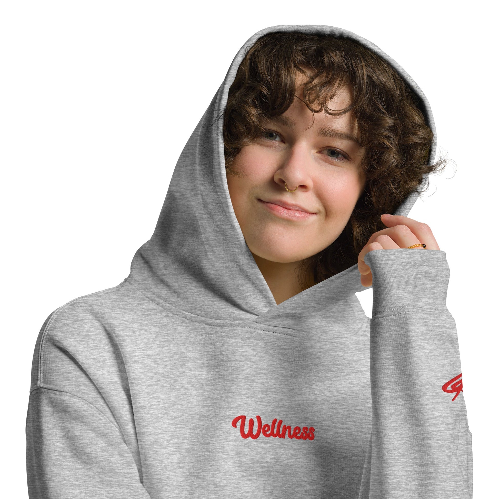 A model wearing The Angel Wellness Hoodie, showing the oversized fit and the embroidered "Wellness" text on the chest.