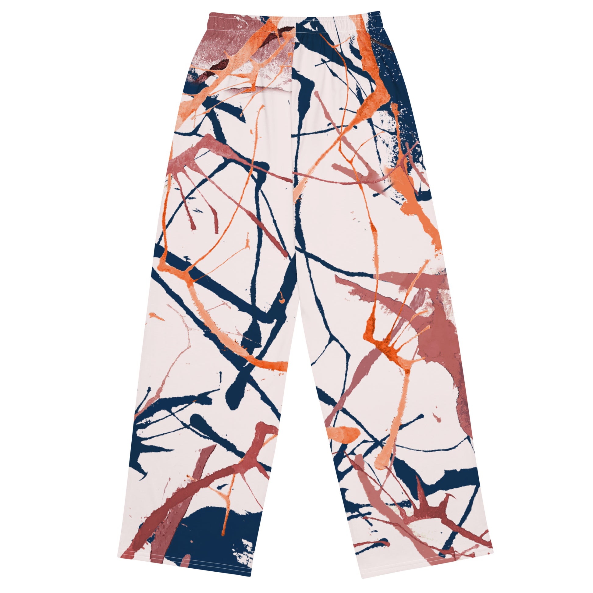 The angle flow joggers. A pair of  wide-leg pants featuring an abstract paint splatter pattern in orange, navy blue, and terracotta on a light cream background, shown flat against a white background.