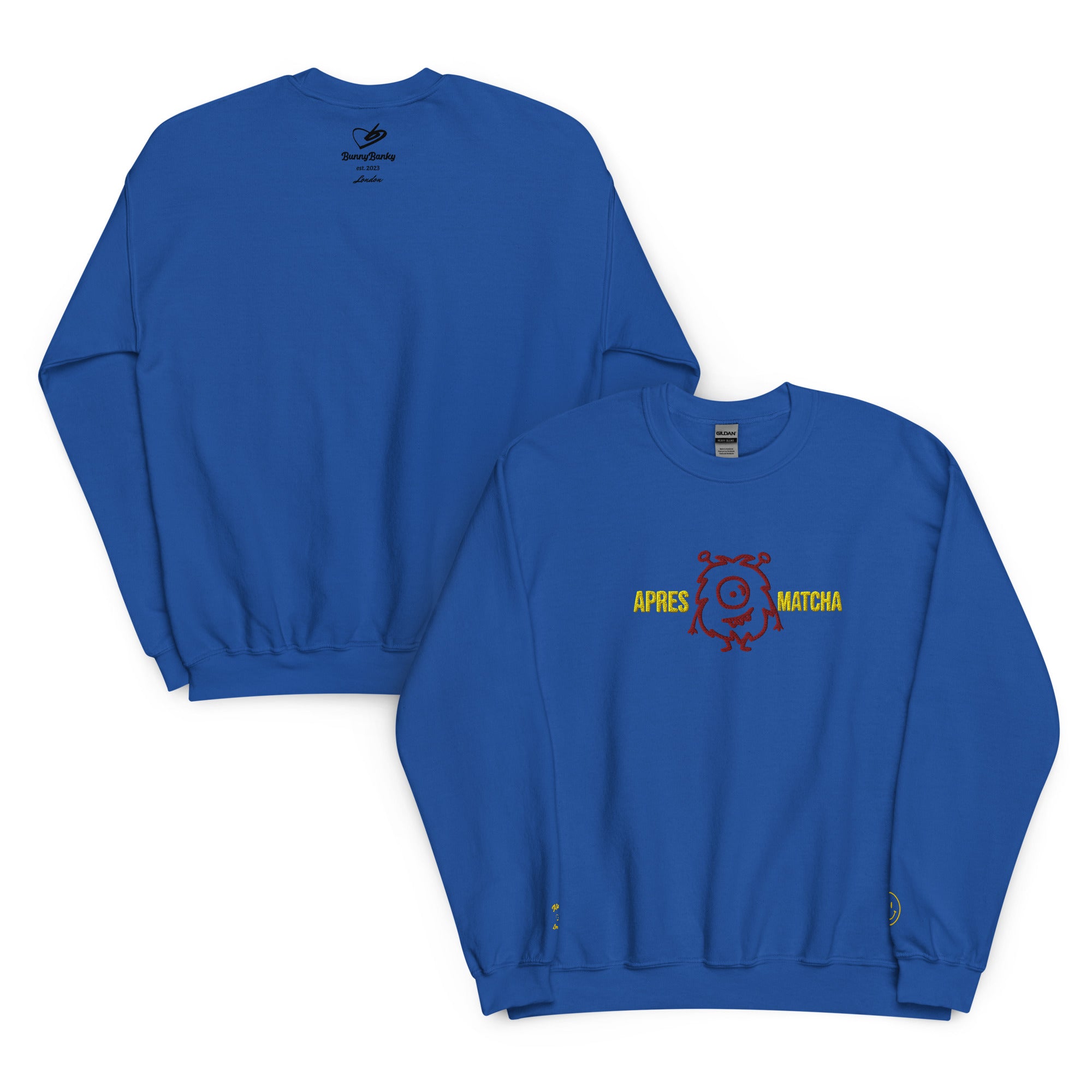 front and back of the apres matcha sweatshirt, a  royal blue crewneck sweatshirts shown on a white background, one displaying the back with a small black graphic and the other showing the front with a yellow and red 'APRÈS MATCHA' graphic.