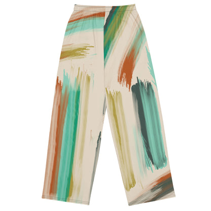 the artful aura flow joggers. high-waisted, wide-leg pants featuring an abstract brushstroke pattern in beige, brown, teal, and green, set against a plain white background.