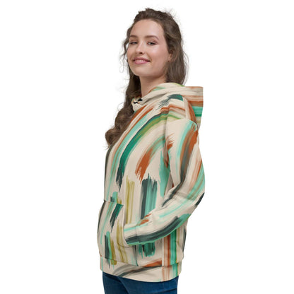 A model wearing The Artful Aura Hoodie, showing the relaxed, oversized fit and the soft pastel green brushstroke print on a beige background.