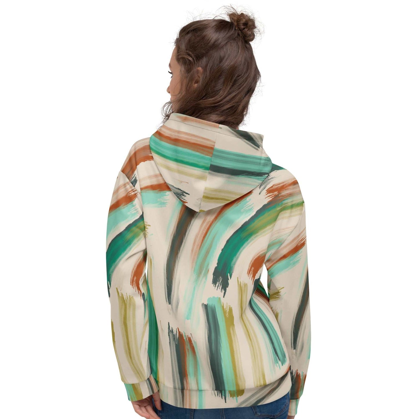 A model wearing The Artful Aura Hoodie, showing the relaxed, oversized fit and the soft pastel green brushstroke print on a beige background.