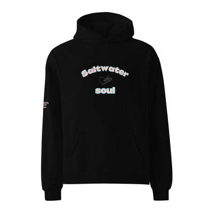 Aclose up of The Azimuth Oversized Hoodie, showing the relaxed fit, drawstring hood, and "Saltwater Soul" text arched around the heart logo on the chest.
