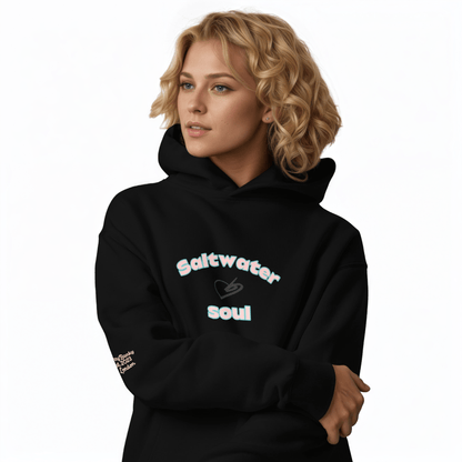 A model wearing The Azimuth Oversized Hoodie, showing the relaxed fit, drawstring hood, and "Saltwater Soul" text arched around the heart logo on the chest.