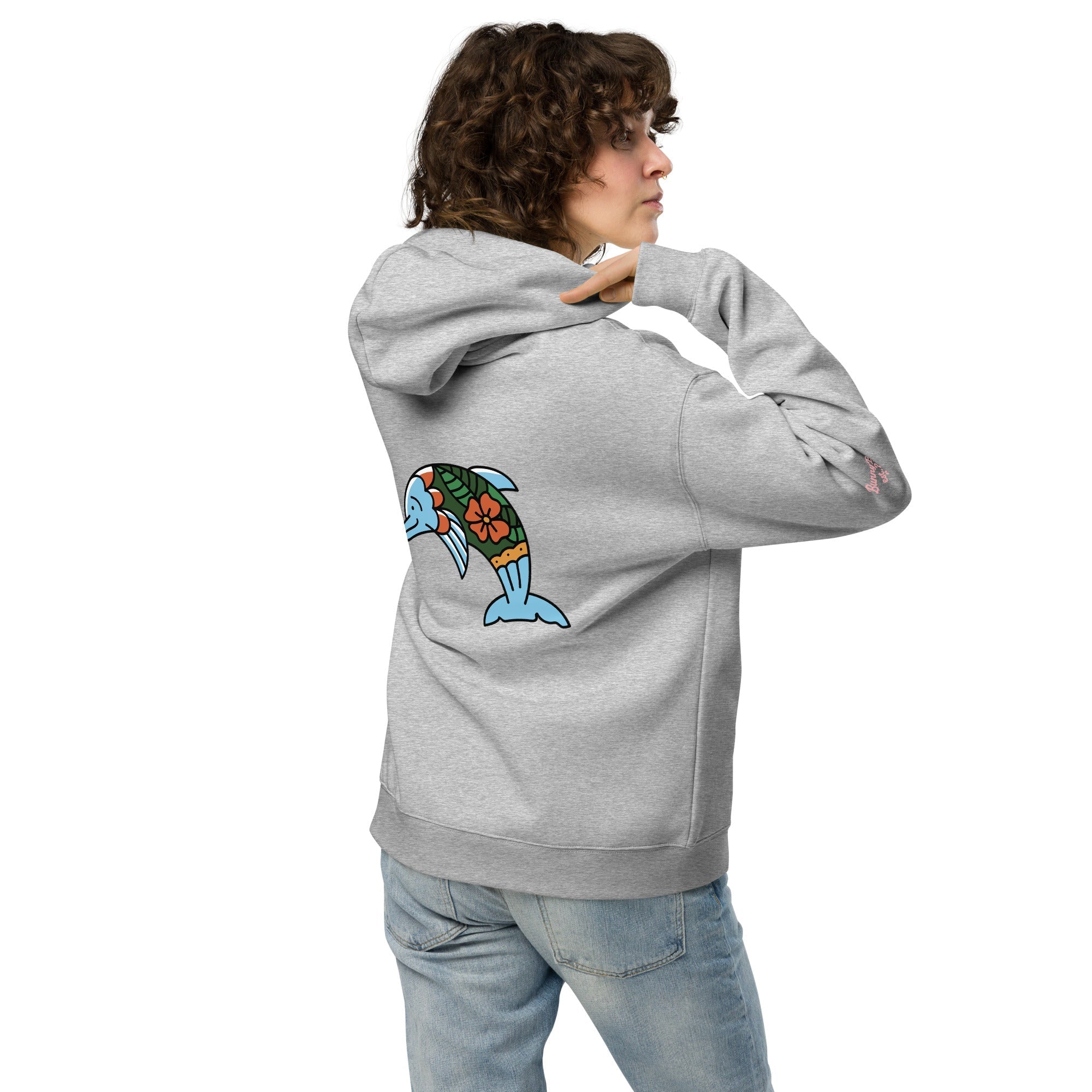 A model wearing The Azimuth Oversized Hoodie, showing the relaxed fit, drawstring hood, and the dolphin print on the back.