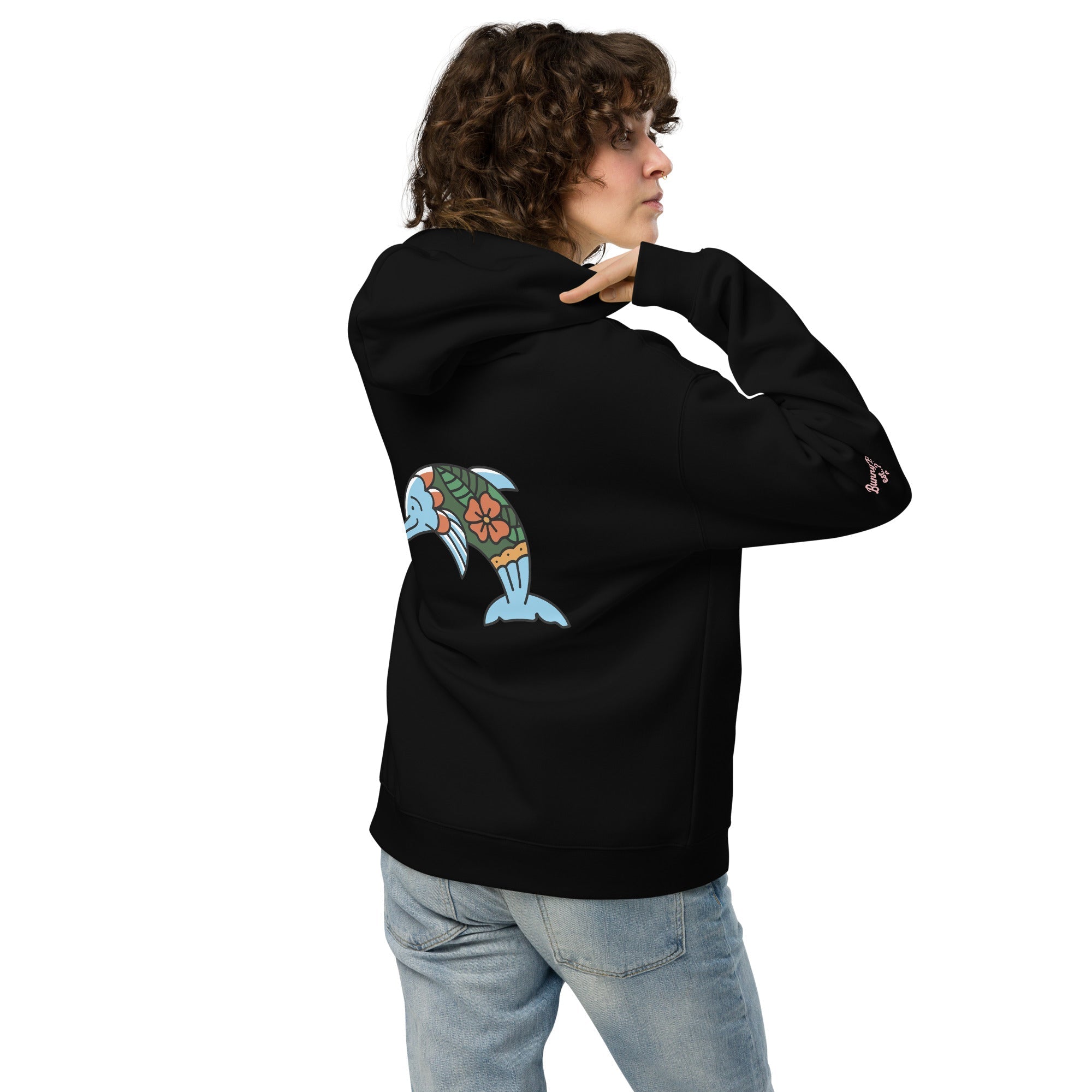 A model wearing The Azimuth Oversized Hoodie, showing the relaxed fit, drawstring hood, and the dolphin print on the back.