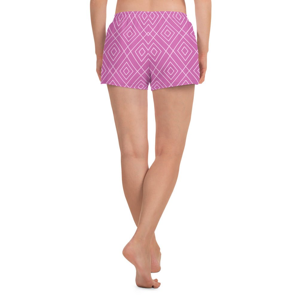 A model wearing the Bahamas Athletic Shorts, featuring an elaborate pink and white geometric lattice print.