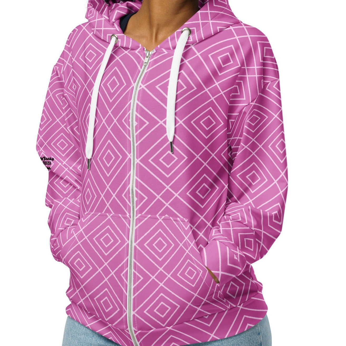 model wearing the Bahamas Zip Hoodie, showcasing the elaborate white diamond lattice print on a vibrant pink background.