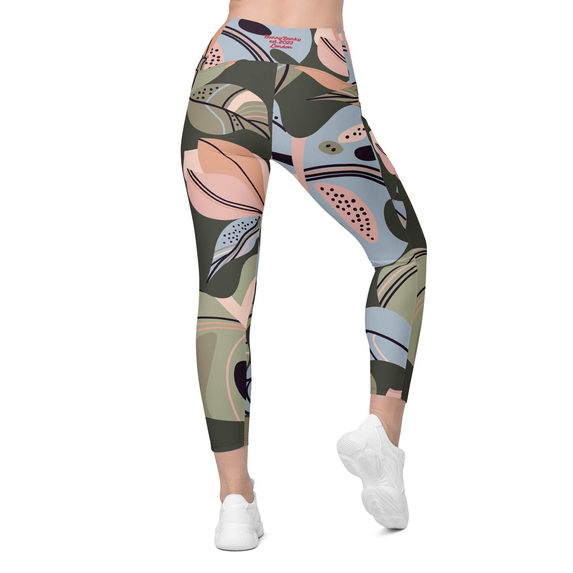 A model wearing The Barbican Sculpt Leggings, showing the sculpting fit and the pastel green and pink exotic flower print.