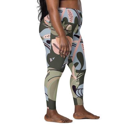 A plus size model wearing The Barbican Sculpt Leggings, showing the sculpting fit and the pastel green and pink exotic flower print.