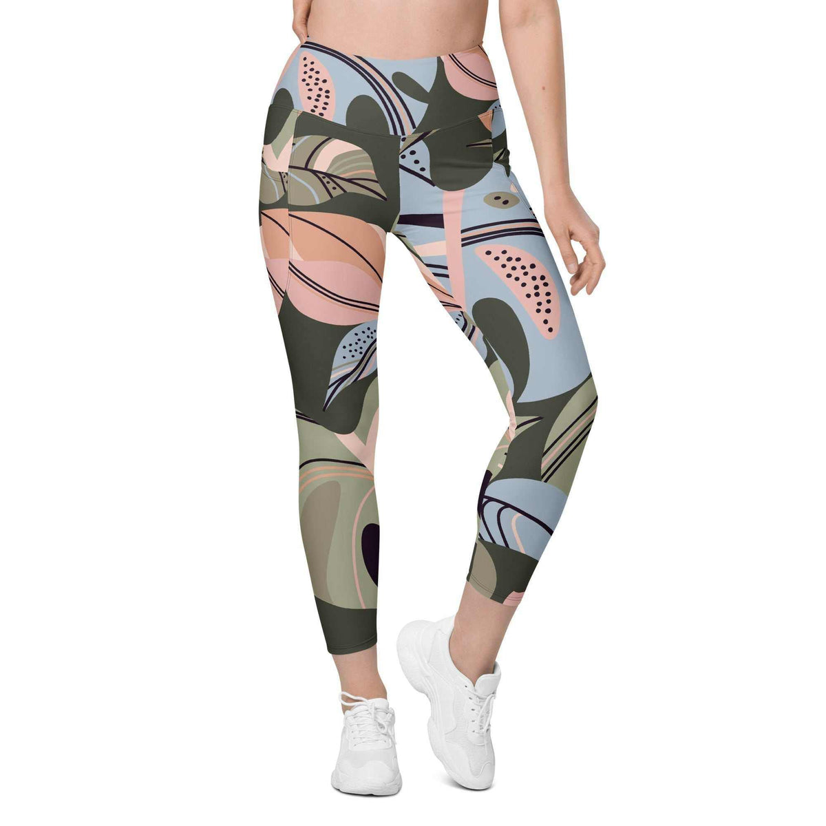 A model wearing The Barbican Sculpt Leggings, showing the sculpting fit and the pastel green and pink exotic flower print.