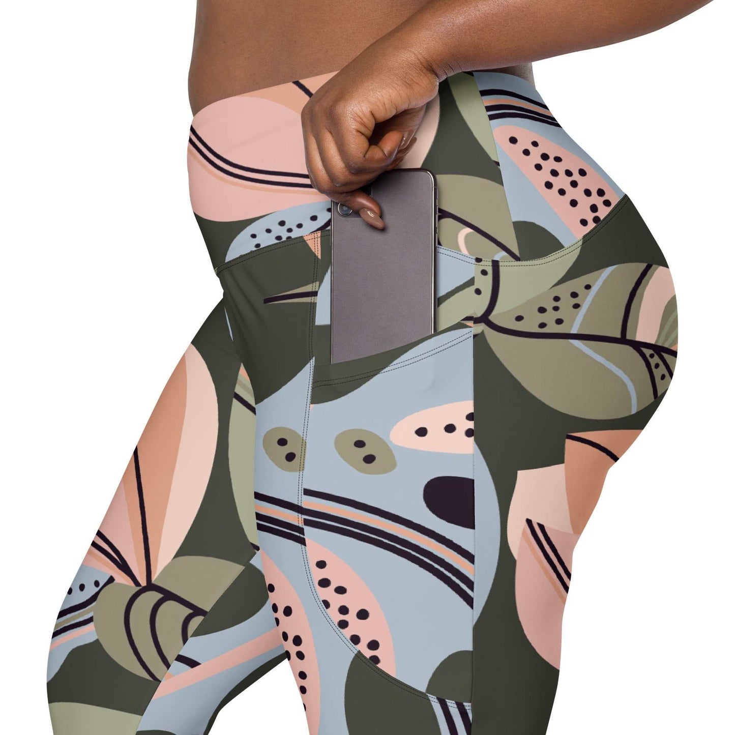 A close-up of The Barbican Sculpt Leggings' elegant, exotic flower print, showing the deep side pocket and the soft, recycled fabric.