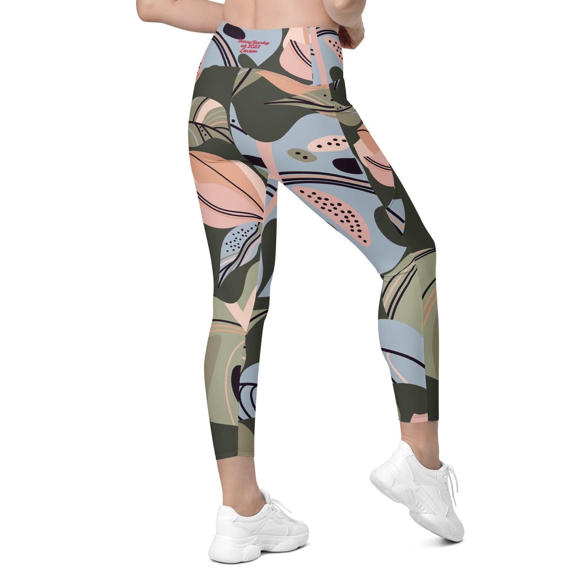 A model wearing The Barbican Sculpt Leggings, showing the sculpting fit and the pastel green and pink exotic flower print.