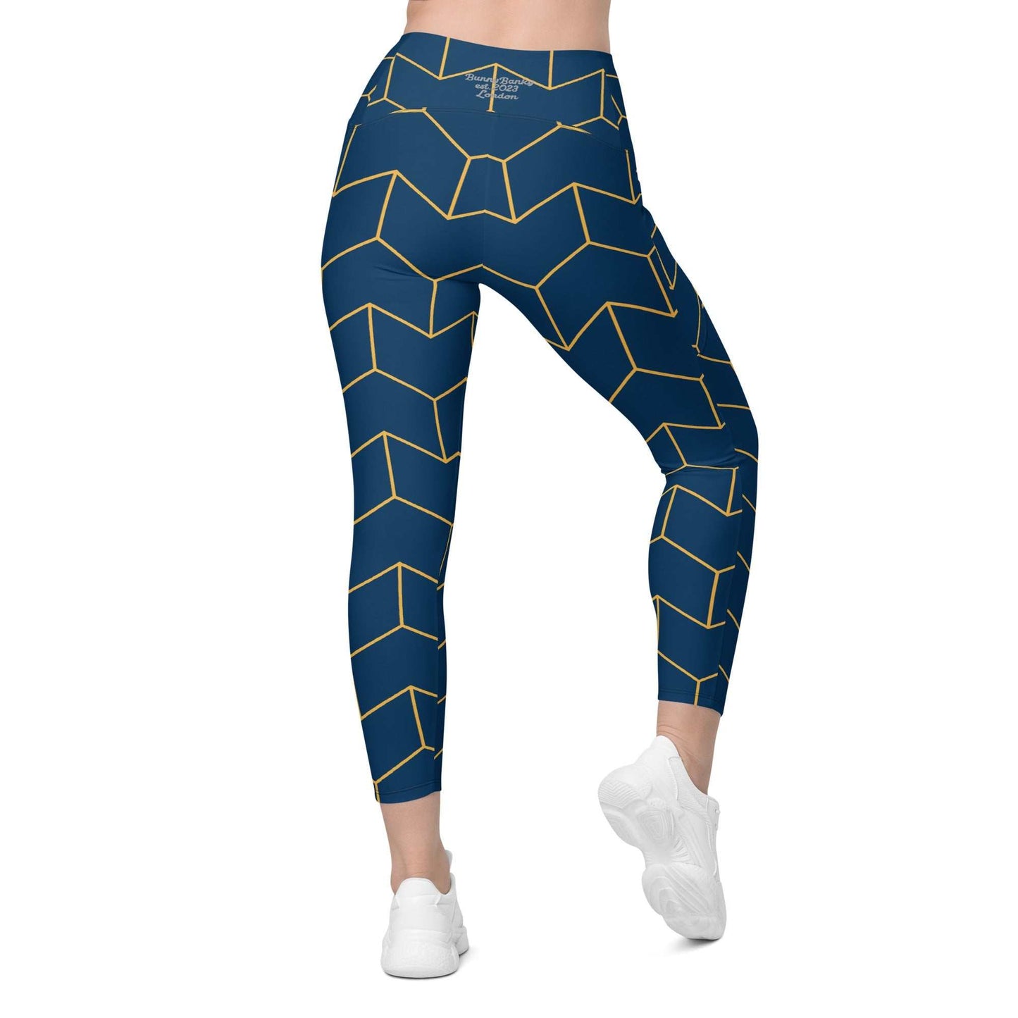 A model wearing The Barons Court Sculpt Leggings showing the matching navy and yellow Art Deco print.