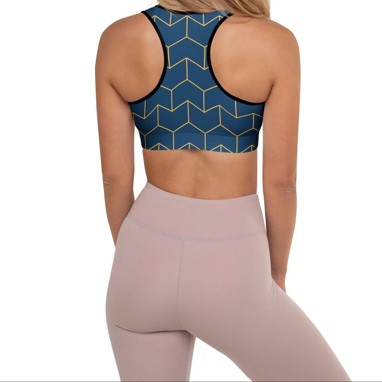A model wearing The Barons Court Performance Bra, showing the supportive fit and the signature navy blue and yellow Art Deco print.
