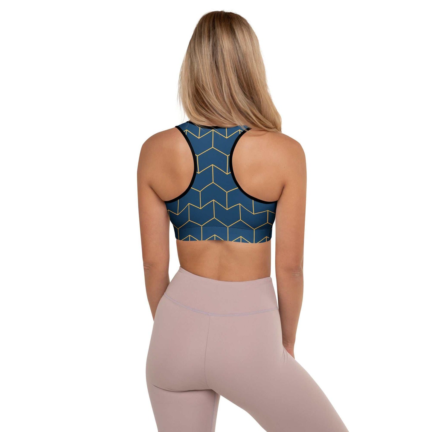 A model wearing The Barons Court Performance Bra, showing the supportive fit and the signature navy blue and yellow Art Deco print.