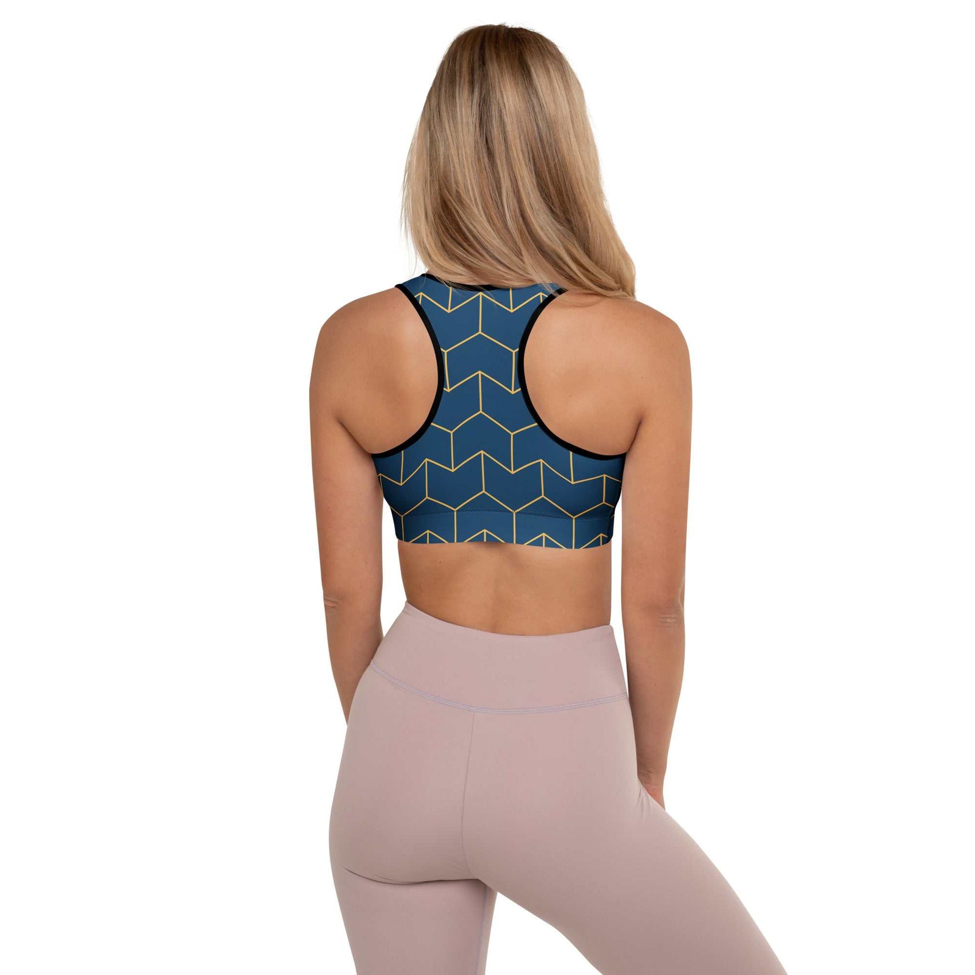 A model wearing The Barons Court Performance Bra, showing the supportive fit and the signature navy blue and yellow Art Deco print.