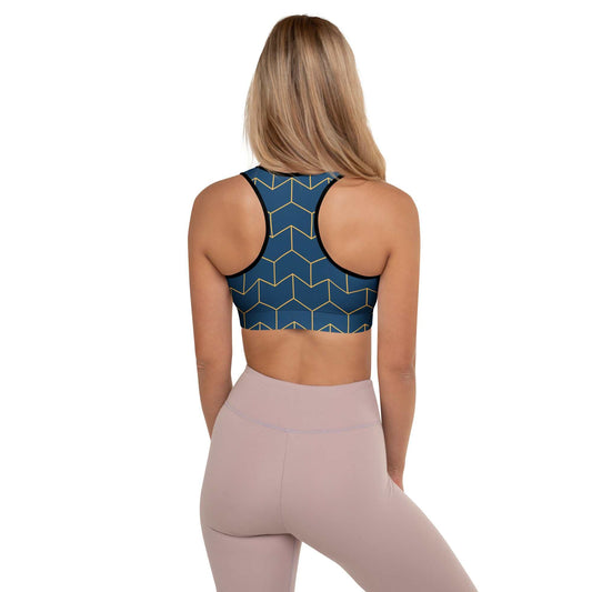 A model wearing The Barons Court Performance Bra, showing the supportive fit and the signature navy blue and yellow Art Deco print.