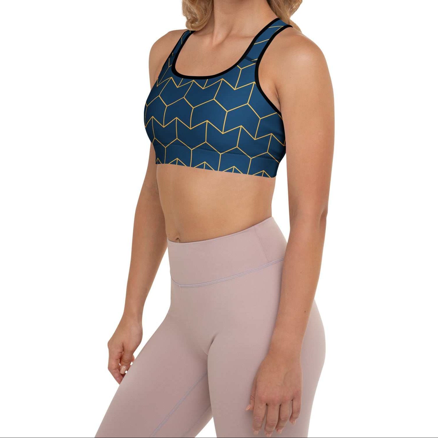 A model wearing The Barons Court Performance Bra, showing the supportive fit and the signature navy blue and yellow Art Deco print.