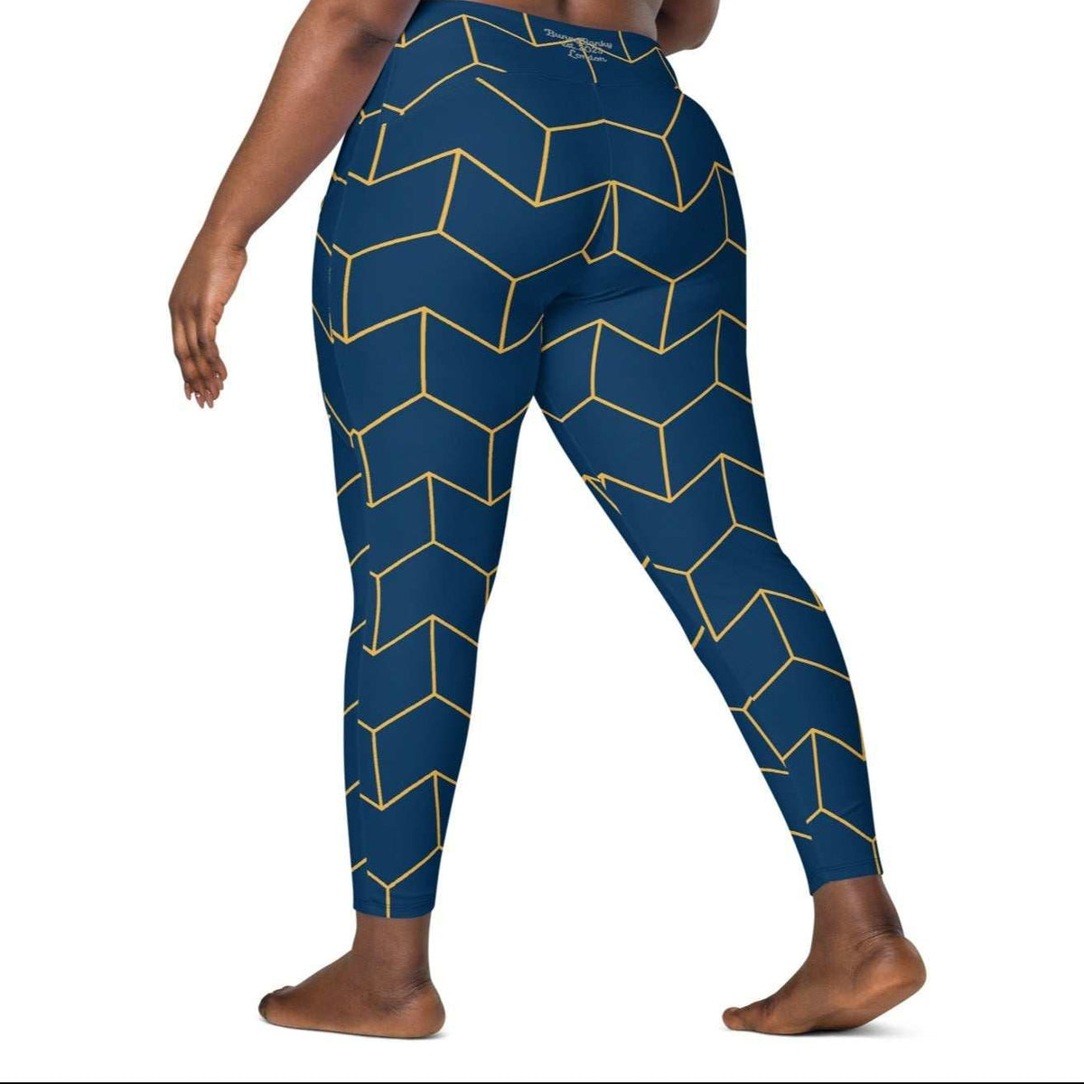A model wearing The Barons Court Sculpt Leggings showing the matching navy and yellow Art Deco print.