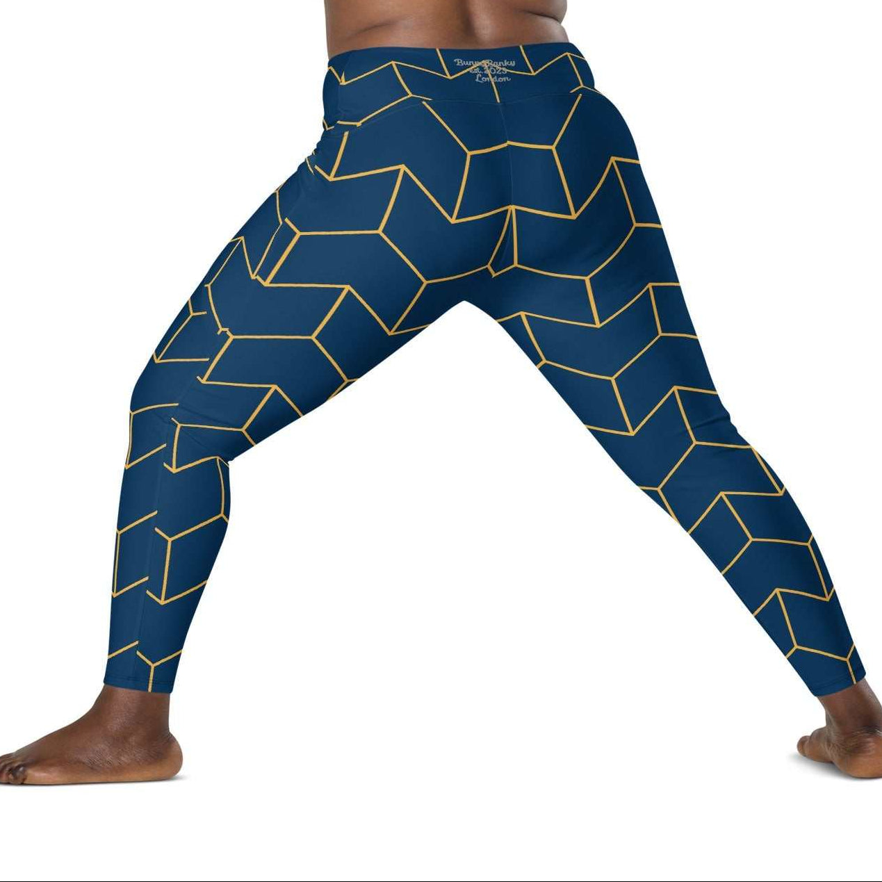 A model wearing The Barons Court Sculpt Leggings showing the matching navy and yellow Art Deco print.