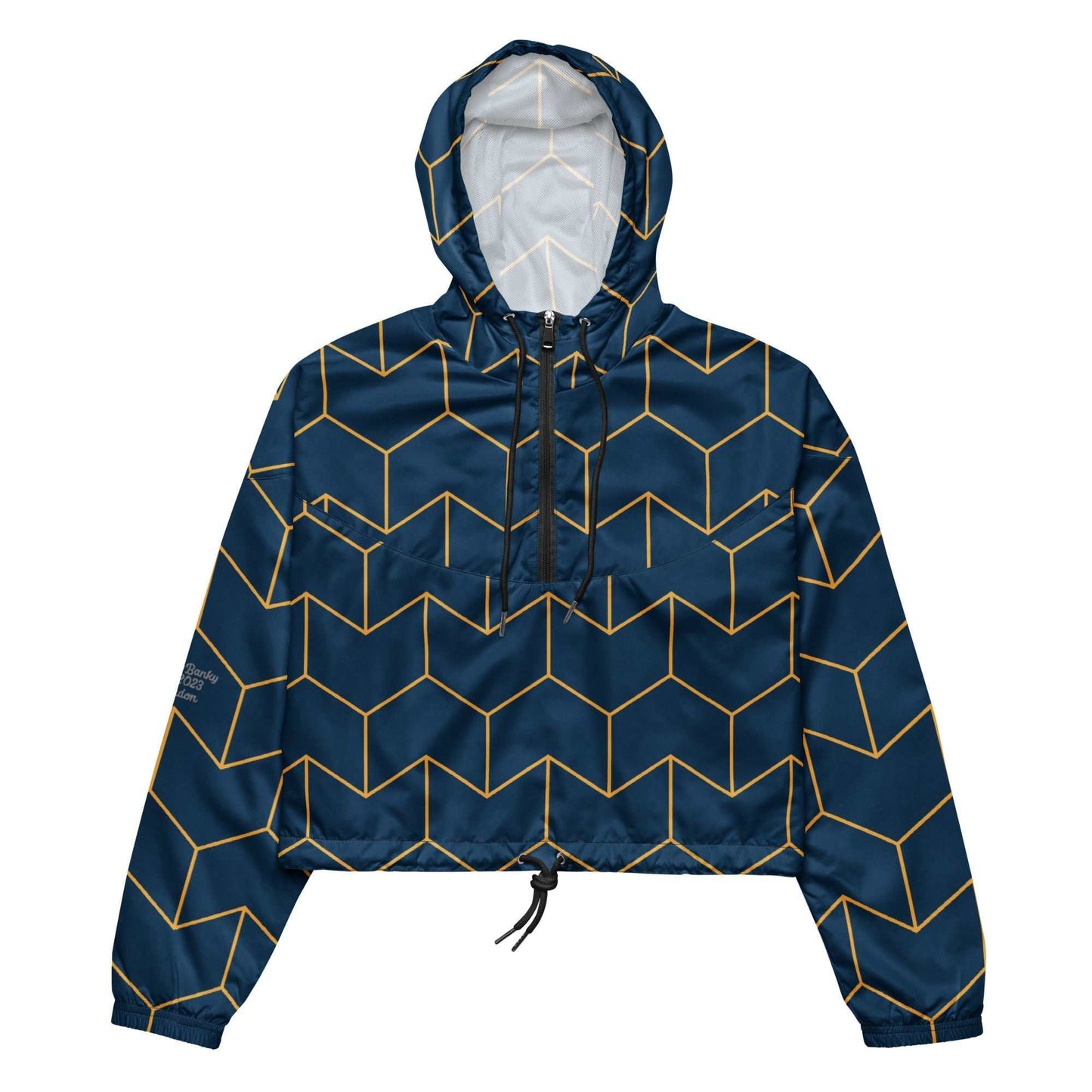 A close-up of The Baron's Court Windbreaker's navy blue and yellow Art Deco print, showing the recycled technical fabric, zip, and quality stitching.
