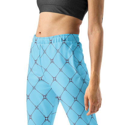 A model wearing the Belgravia Slim Fit Joggers in the burgundy monogram print, showing the tailored fit against the light blue background.