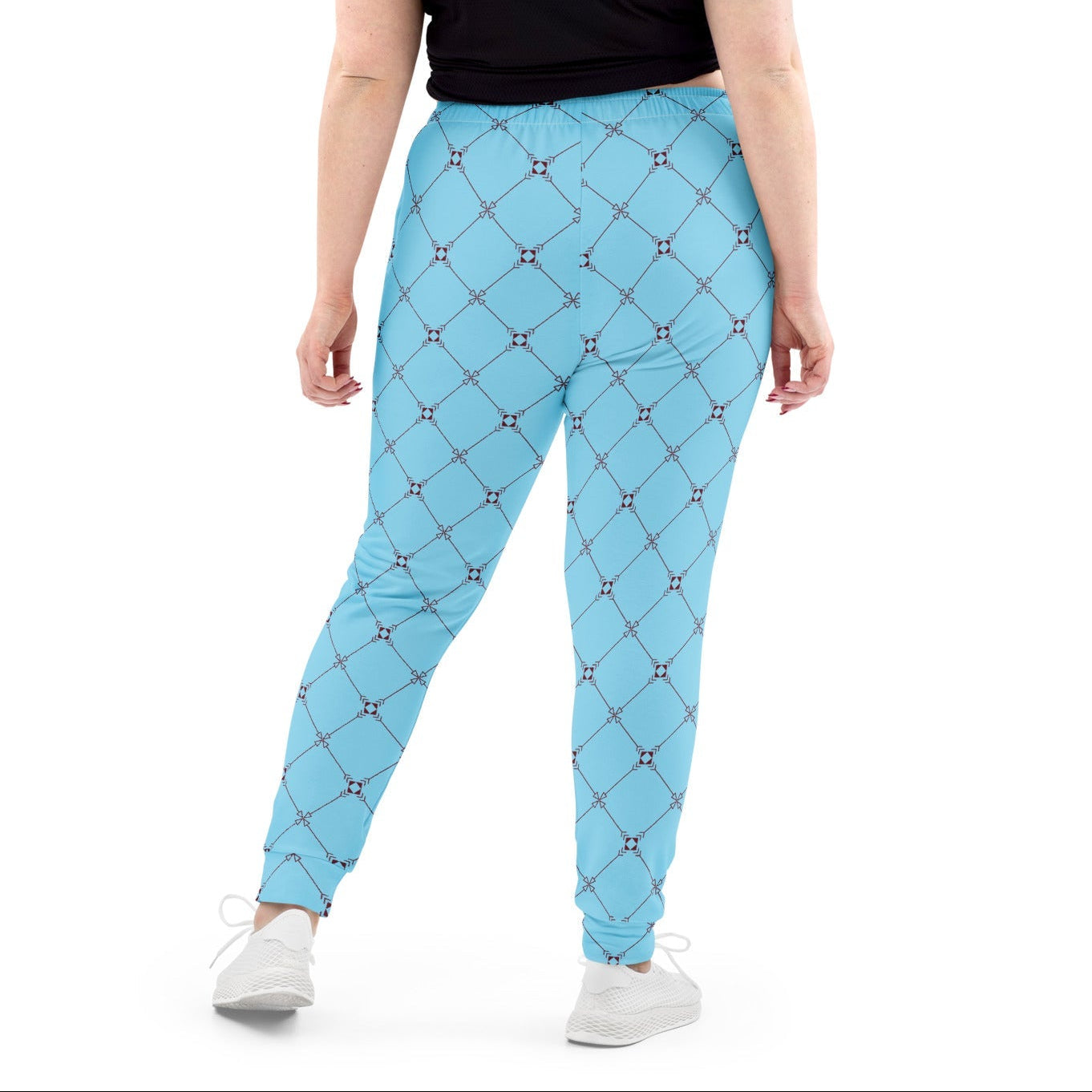 A model wearing the Belgravia Slim Fit Joggers in the burgundy monogram print, showing the tailored fit against the light blue background.