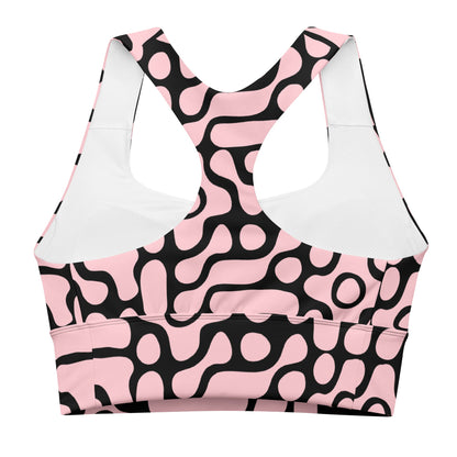 the Berlin Performance Bra in black geometric floral pattern on pink background